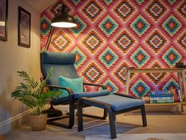 A living room with an armchair and footrest at Riverside Park 5 in Keswick