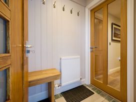 A hallway with a bench and hooks at Riverside Park 5 in Keswick
