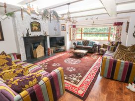 A living room with a television and sofas at The Woodlands Lower Level Stepaside