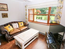 A living room with a sofa and coffee table at The Woodlands Lower Level Stepaside