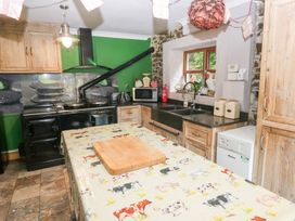 A kitchen with wooden cabinetry and appliances at The Woodlands Lower Level in Stepaside