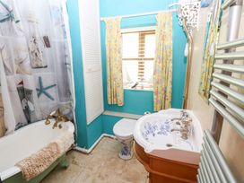 A bathroom with a bathtub and sink at The Woodlands Lower Level Stepaside
