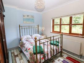 A bedroom with a bed and window at The Woodlands Lower Level Stepaside