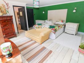 A bedroom with a bed and sofa at The Woodlands Lower Level Stepaside