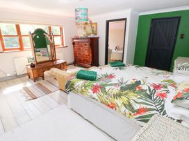 A bedroom with a bed and a wardrobe at The Woodlands Lower Level Stepaside