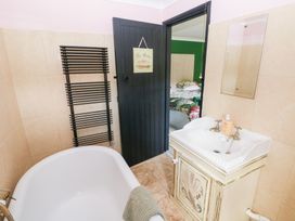 A bathroom with a bathtub and sink at The Woodlands Lower Level Stepaside