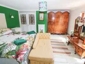 A bedroom with a bed and wardrobe at The Woodlands Lower Level in Stepaside