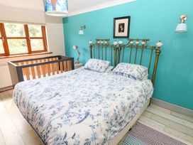 A bedroom with a bed and crib at The Woodlands Lower Level in Stepaside