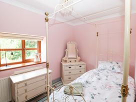 A bedroom with a bed and a chest of drawers at The Woodlands Lower Level in Stepaside