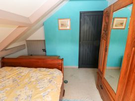 A bedroom with a bed and wardrobe at The Woodlands Lower Level in Stepaside