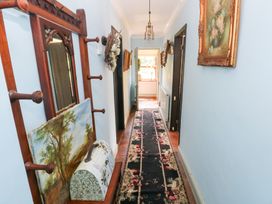 A hallway with a mirror and artwork at The Woodlands Lower Level in Stepaside