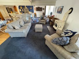 A living room with sofas and a fireplace at Bethel Chapel in Staithes