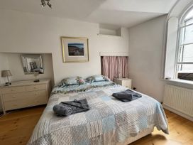 A bedroom with a bed and dresser at Bethel Chapel in Staithes
