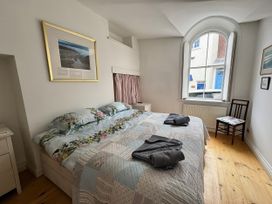A bedroom with a bed and window at Bethel Chapel in Staithes