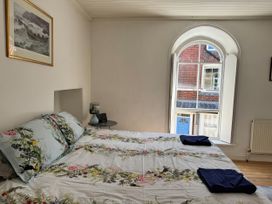 A bedroom with a bed and window at Bethel Chapel in Staithes