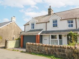 A house with a garage and a garden wall at Bryn Awel Mynytho near Abersoch