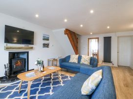 A living room with sofa and television at Bryn Awel in Mynytho near Abersoch