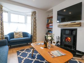 A living room with a sofa and coffee table at Bryn Awel in Mynytho near Abersoch