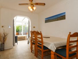 A dining room with a table and chairs at Bryn Awel in Mynytho near Abersoch