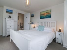 A bedroom with a bed and nightstand at Bryn Awel in Mynytho near Abersoch