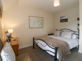 A bedroom with a bed and table at Bryn Awel Mynytho near Abersoch