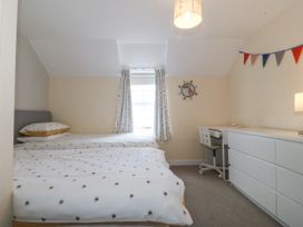 A bedroom with two beds and a desk at Bryn Awel in Mynytho near Abersoch