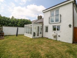 A house with a conservatory and garden at Bryn Awel in Mynytho near Abersoch
