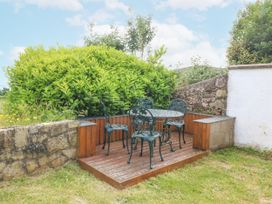 An outdoor seating area with a table and chairs at Bryn Awel in Mynytho near Abersoch