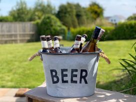 A bucket with beer bottles on a table at Gilfach Abersoch