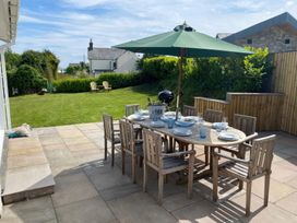 An outdoor dining area with a table and chairs at Gilfach in Abersoch