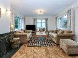 A living room with sofas and a television at Lane End in Abersoch