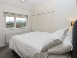 A bedroom with a bed and window at Lane End in Abersoch