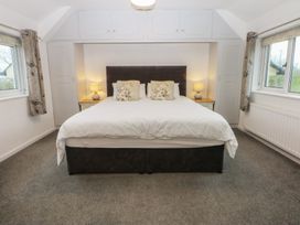A bedroom with a bed and bedside tables at Lane End in Abersoch
