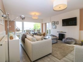 A living room with a sofa and coffee table at Nyth Y Fran in Abersoch