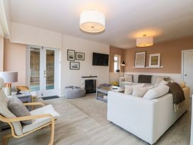 A living room with a sofa and coffee table at Nyth Y Fran in Abersoch