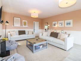 A living room with a sofa and coffee table at Nyth Y Fran in Abersoch