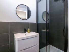A bathroom with a sink and shower at Nyth Y Fran in Abersoch