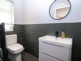 A bathroom with a toilet and sink at Nyth Y Fran Abersoch
