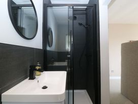 A bathroom with a shower and sink at Nyth Y Fran Abersoch