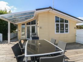 An outdoor dining area with a table and chairs at The Warren D26 Abersoch
