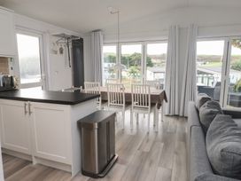 A kitchen with dining area and sofa at The Warren D7 Abersoch