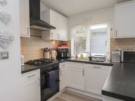 A kitchen with a stove and sink at The Warren D7, Abersoch