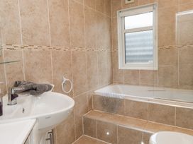 A bathroom with a bath and sink at The Warren D7 in Abersoch