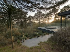 An outdoor seating area with trees and a platform at Landmark in Salcombe