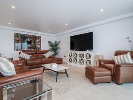 A living room with a sofa and television at 13 Cliff Edge in Newquay