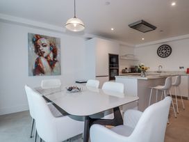 A kitchen with a dining table and chairs at 13 Cliff Edge in Newquay