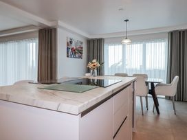 A kitchen with a countertop and dining area at 13 Cliff Edge in Newquay