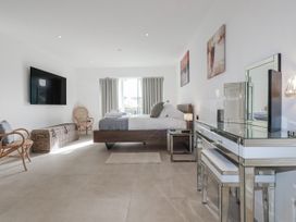 A bedroom with a bed and television at 13 Cliff Edge in Newquay