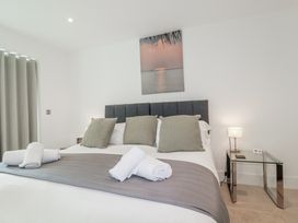 A bedroom with a bed and bedside table at 13 Cliff Edge Newquay