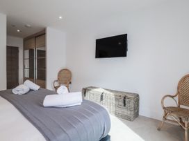 A bedroom with a bed and storage box at 13 Cliff Edge in Newquay
